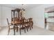 Formal dining room with a wood table, chairs, china cabinet, and view to the kitchen at 2205 Parliament Dr, Lawrenceville, GA 30043