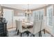 Dining room with decorative chandelier, wainscoting, large windows, and seating for eight at 2205 Parliament Dr, Lawrenceville, GA 30043