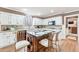 Bright kitchen with island seating, granite countertops, white cabinets, and stainless steel appliances at 2205 Parliament Dr, Lawrenceville, GA 30043