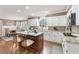 Bright kitchen with an island, breakfast bar, white cabinets, and view of the dining area at 2205 Parliament Dr, Lawrenceville, GA 30043