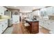 Open kitchen with an island, white cabinets, granite counters, and stainless steel appliances at 2205 Parliament Dr, Lawrenceville, GA 30043