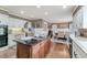 Well-lit kitchen with white cabinets, granite countertops, an island, and stainless appliances at 2205 Parliament Dr, Lawrenceville, GA 30043