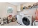 Laundry room featuring a washer, dryer, and storage shelving at 2205 Parliament Dr, Lawrenceville, GA 30043