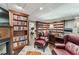 Basement library offers floor-to-ceiling bookshelves, a fireplace and ample seating at 2205 Parliament Dr, Lawrenceville, GA 30043