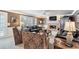 Cozy living room with a brick fireplace, brown leather furniture, and ceiling fan at 2205 Parliament Dr, Lawrenceville, GA 30043