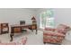Well-lit office space with a traditional desk and two accent chairs at 2205 Parliament Dr, Lawrenceville, GA 30043