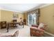 Bright office featuring neutral carpet, a large window with floral curtains, and a traditional desk at 2205 Parliament Dr, Lawrenceville, GA 30043
