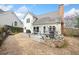 Backyard featuring a concrete patio, dining set, grill, well-kept lawn and landscaped perimeter at 2692 Glenrose Hl, Atlanta, GA 30341