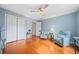 Spacious bedroom with hardwood floors, a ceiling fan, and comfortable armchairs by side tables with lamps at 2692 Glenrose Hl, Atlanta, GA 30341
