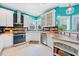 Beautiful kitchen featuring white cabinets, stainless steel appliances, and turquoise walls at 2692 Glenrose Hl, Atlanta, GA 30341