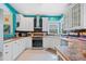 Well-lit kitchen with stainless steel appliances, white cabinets, and butcher block countertops at 2692 Glenrose Hl, Atlanta, GA 30341