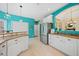 Open kitchen layout with white cabinets, stainless steel refrigerator, and breakfast bar at 2692 Glenrose Hl, Atlanta, GA 30341