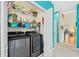 Modern laundry room featuring front loading washer and dryer and extra shelving at 2692 Glenrose Hl, Atlanta, GA 30341