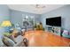 Relaxing living room featuring hardwood floors, a big screen TV, and lots of seating at 2692 Glenrose Hl, Atlanta, GA 30341