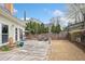 Concrete patio featuring an outdoor dining set, swing, barbecue grill, and a landscaped yard at 2692 Glenrose Hl, Atlanta, GA 30341