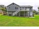 Spacious backyard featuring a deck with stairs, patio area, and well-maintained lawn at 4090 Mark Todd Ct, Hoschton, GA 30548