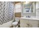 Bathroom featuring shower/tub, natural window shade, vanity, and wood flooring at 4090 Mark Todd Ct, Hoschton, GA 30548