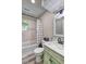 Bathroom with modern vanity, and marble tiled walls above the tub with shower at 4090 Mark Todd Ct, Hoschton, GA 30548