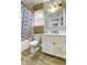 Bathroom featuring shower/tub, natural window shade, vanity, and wood flooring at 4090 Mark Todd Ct, Hoschton, GA 30548