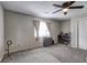 Cozy bedroom with neutral carpet, fan, and a window providing natural light at 4090 Mark Todd Ct, Hoschton, GA 30548