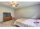 Bedroom featuring carpeted floors, a TV, and neutral colors for a cozy ambiance at 4090 Mark Todd Ct, Hoschton, GA 30548