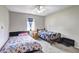 Bright bedroom featuring twin beds, neutral walls, ceiling fan, and carpet flooring at 4090 Mark Todd Ct, Hoschton, GA 30548