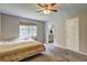 Comfortable bedroom with a window view, carpeted floors, and access to an en-suite bathroom at 4090 Mark Todd Ct, Hoschton, GA 30548