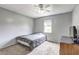 Cozy bedroom with natural light, ceiling fan, carpet flooring, and simple decor at 4090 Mark Todd Ct, Hoschton, GA 30548