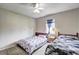 Bright bedroom featuring twin beds, neutral walls, ceiling fan, and carpet flooring at 4090 Mark Todd Ct, Hoschton, GA 30548