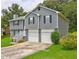 Charming two-story home featuring a two-car garage, gray siding, and a well-maintained front yard with mature trees at 4090 Mark Todd Ct, Hoschton, GA 30548