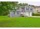 Well-kept two-story home featuring a neatly manicured lawn, a red front door, and an attached two-car garage at 4090 Mark Todd Ct, Hoschton, GA 30548