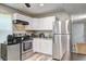 Kitchen featuring stainless steel appliances, white cabinetry, and tile flooring at 4090 Mark Todd Ct, Hoschton, GA 30548