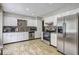 Kitchen with stainless steel appliances, white cabinetry, tile backsplash and wood floors at 4090 Mark Todd Ct, Hoschton, GA 30548