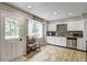 Charming kitchen featuring white cabinets, a mosaic backsplash, and stainless steel appliances at 4090 Mark Todd Ct, Hoschton, GA 30548