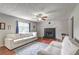 Living room with a black brick fireplace, hardwood floors and lots of natural light at 4090 Mark Todd Ct, Hoschton, GA 30548