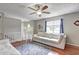Upstairs living room featuring wood floors, white railing and a ceiling fan at 4090 Mark Todd Ct, Hoschton, GA 30548