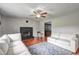Living room with a brick fireplace, hardwood floors and lots of natural light at 4090 Mark Todd Ct, Hoschton, GA 30548