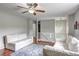Upstairs living room featuring hardwood floors, white railing and ceiling fan at 4090 Mark Todd Ct, Hoschton, GA 30548