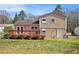 Exterior home featuring backyard, lush grass, wooden deck, and neutral-toned siding at 1736 Inas Way, Tucker, GA 30084