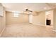 Finished basement with neutral carpet, ceiling fan, and access to additional rooms at 1736 Inas Way, Tucker, GA 30084