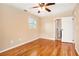 Bedroom features hardwood floors, neutral walls, and a ceiling fan at 1736 Inas Way, Tucker, GA 30084