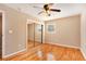 Bedroom with hardwood floors, ceiling fan, closet with mirror doors, and neutral walls at 1736 Inas Way, Tucker, GA 30084