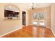 Dining area with hardwood floors, french doors, and an open view to the kitchen at 1736 Inas Way, Tucker, GA 30084