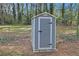 Outdoor shot of grey storage shed in a fenced in yard, surrounded by leaf litter at 1736 Inas Way, Tucker, GA 30084
