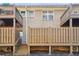 Exterior view of back brick facade with wooden staircases leading to upper-level balconies. Unit numbers visible at 2232 Dunseath Nw Ave # 303, Atlanta, GA 30318