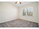 Clean and empty bedroom featuring plush carpet, natural light, and ceiling fan at 2232 Dunseath Nw Ave # 303, Atlanta, GA 30318