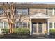 Charming townhome featuring a brick facade, black shutters, and covered entryway at 2232 Dunseath Nw Ave # 303, Atlanta, GA 30318
