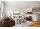 Cozy living room with bright natural light, hardwood floors, and view into the kitchen at 2232 Dunseath Nw Ave # 303, Atlanta, GA 30318