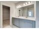 Bathroom vanity with double sinks, gray cabinets, white counter tops and a large mirror at 4041 Andover Cir, Mcdonough, GA 30252