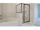 Bathroom showcasing a glass enclosed shower, soaking tub with marble tile surround and a light wall color at 4041 Andover Cir, Mcdonough, GA 30252